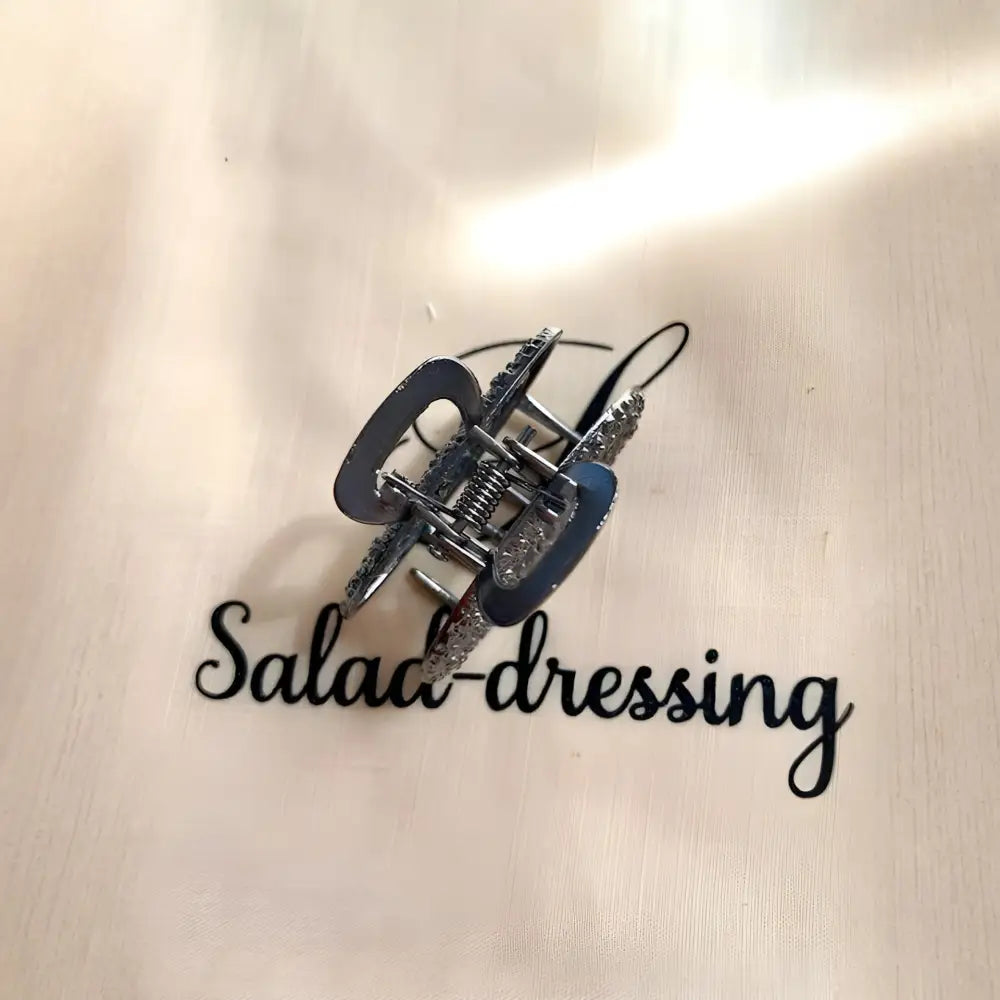Pince noire crabe - motif roses argentées SALMA salad-dressing